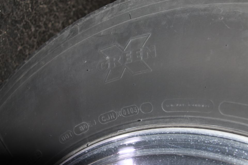 Tire sidewall showing "GREEN X" logo and DOT code with 0103 date stamp