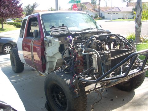 1992 Ford Ranger - This 1992 Ford Ranger is undergoing extensive modifications, with its front end disassembled and a roll cage installed.