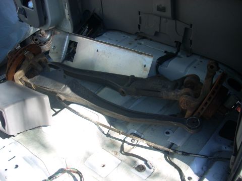 1992 Ford Ranger - Front suspension components are stored inside the cabin of a vehicle.