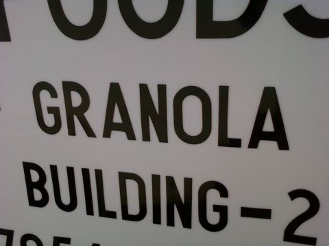 1989 Ford Bronco - A sign displays the words "GRANOLA BUILDING - 2" in large black lettering.