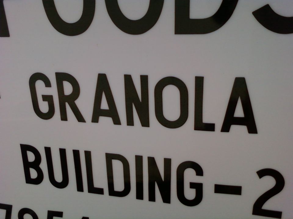 Sign with black text reading "GRANOLA BUILDING - 2" on a white background