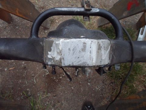 1991 Ford Bronco - Close-up of a rear axle differential housing with a ground metal plate.