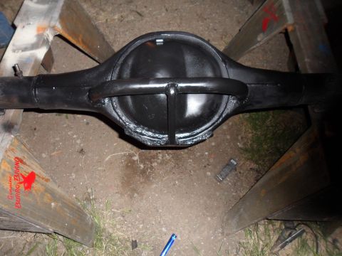 1991 Ford Bronco - A black rear axle differential assembly is shown resting on wooden sawhorses outdoors.