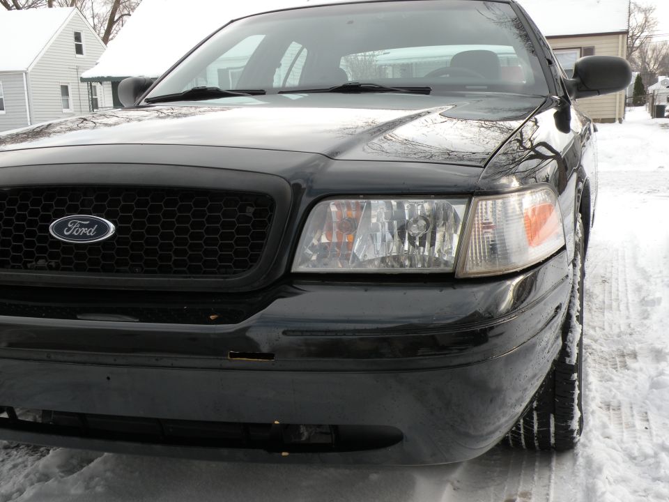 Black 2005 Ford Crown Victoria front end with honeycomb grille and clear headlights