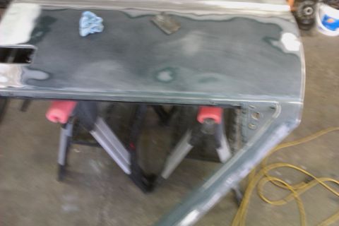 1994 Chevrolet Blazer - Car door undergoing bodywork and repair, resting on sawhorses.