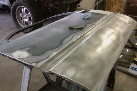 1994 Chevrolet Blazer - A car door is shown with primer and body filler, indicating repair work is underway.