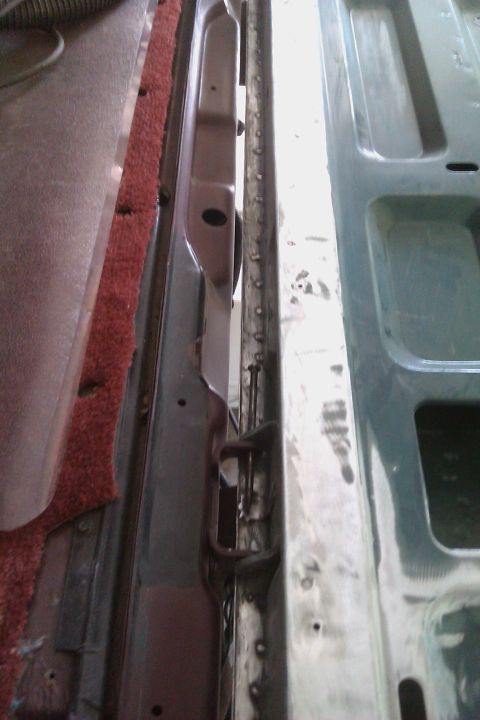 1994 Chevrolet Blazer - Close-up view of the interior door frame and carpet, showing metal structure and some wear.