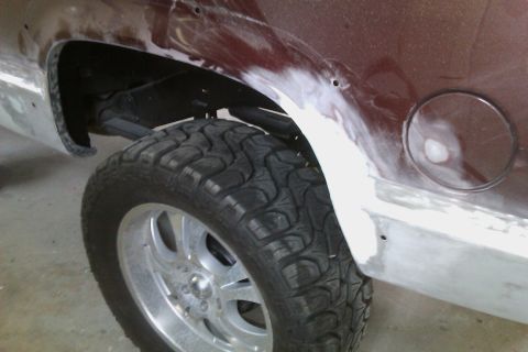 1994 Chevrolet Blazer - The vehicle's rear quarter panel and wheel well are shown with body filler applied, indicating repair or modification.