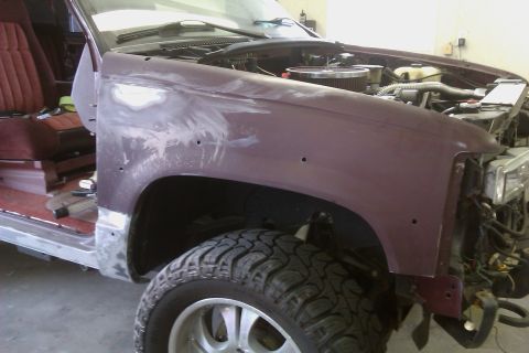 1994 Chevrolet Blazer - This maroon SUV is undergoing repairs, with visible bodywork on the fender and exposed engine components.