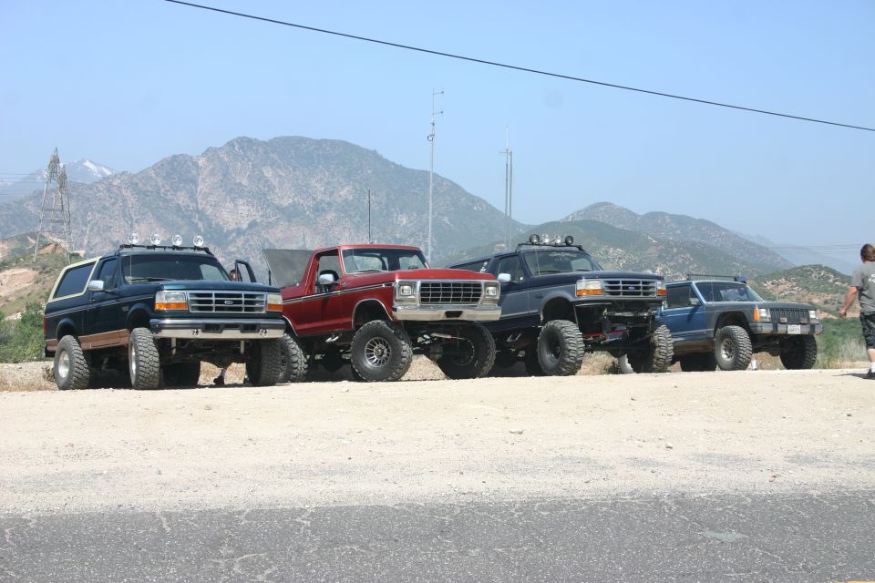 1991 Ford Bronco front 3/4 view, dark green with white top