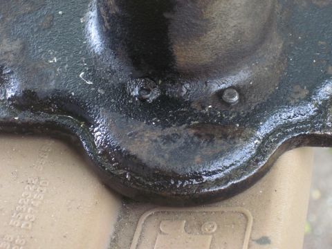 1979 Ford Bronco - Cast iron component with visible bolts and partial text. The year is not discernible.