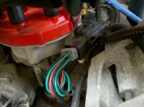 1996 Ford Bronco - Close-up view of engine components including a distributor cap and wiring harness.