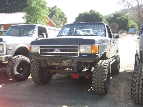 1989 Ford Bronco - This lifted 1989 Ford Bronco features prominent 4x4 badging and a modified suspension system.