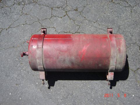 1993 Ford Bronco - This is a red air tank, likely for an aftermarket system, shown on a paved surface.