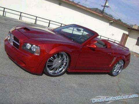2007 Ford Mustang - This red convertible features a heavily modified front end and large chrome wheels.