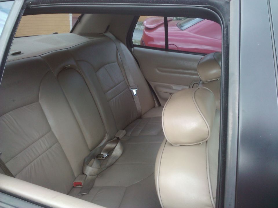 Interior rear seats of a 2001 Ford Crown Victoria, tan leather upholstery