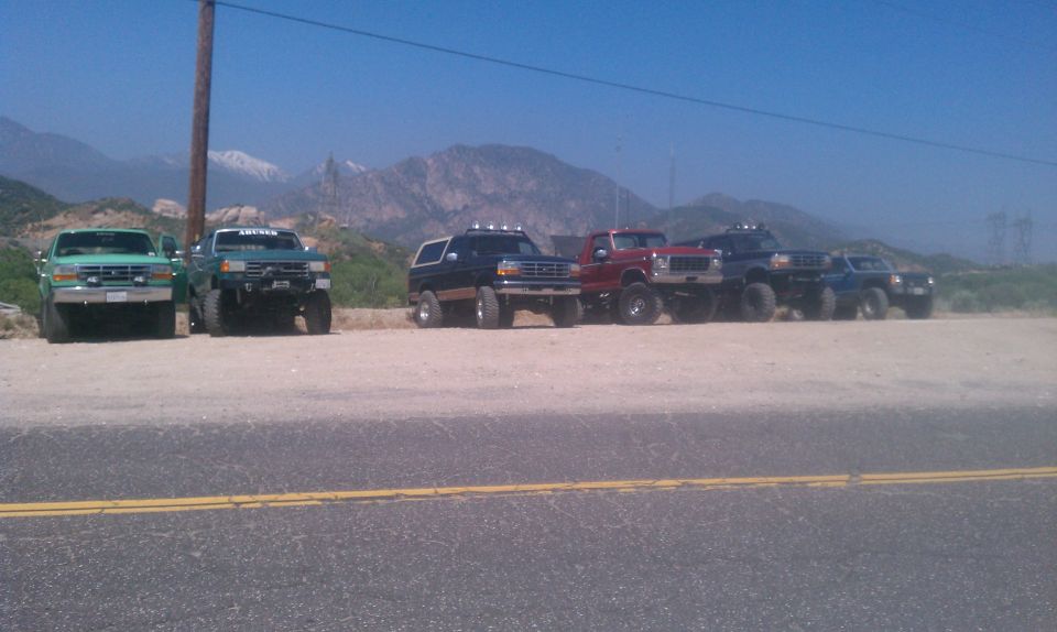 1978 Ford Bronco, black, lifted, parked in a line with other trucks
