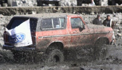1978 Ford Bronco - This 1978 Ford Bronco is navigating a muddy obstacle course, displaying a Ford flag from its rear.