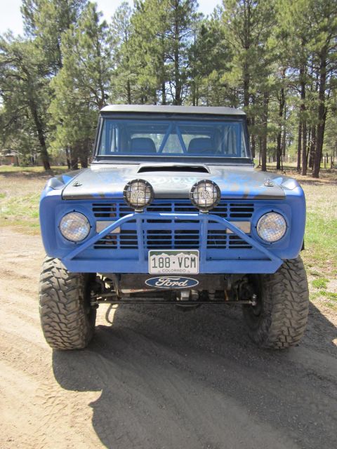 1971 Ford Bronco - A blue Ford Bronco is seen from the front, modified for off-road use.