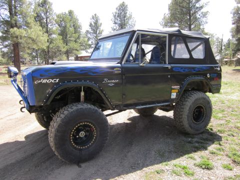 1971 Ford Bronco - This modified 1971 Ford Bronco features a custom blue flame paint job and heavy-duty off-road tires.