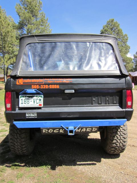 1971 Ford Bronco - Rear view of a 1971 Ford Bronco, a soft top and aftermarket blue bumper.