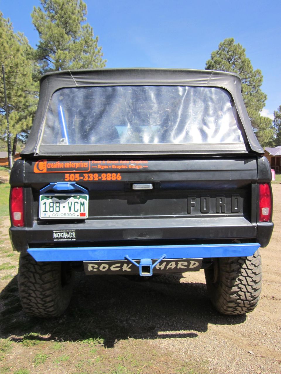 1971 Ford Bronco rear view with soft top, blue bumper, and Colorado license plate 188-VCM