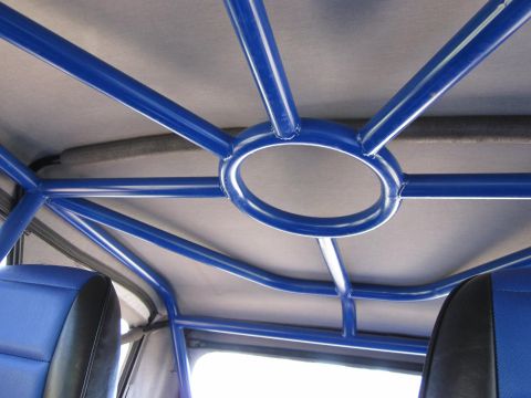 1971 Ford Bronco - The interior of a vehicle shows a blue roll cage and seats, with a Supermotors.net watermark.