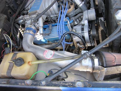 1971 Ford Bronco - Close-up view of a vehicle's engine bay, showing various components and modifications.