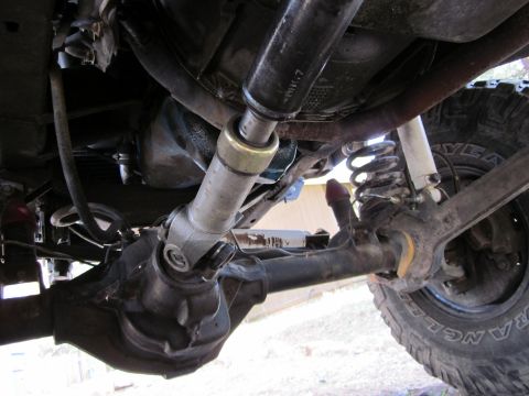 1971 Ford Bronco - The photo shows the rear axle and driveshaft assembly of a vehicle, with suspension components visible.