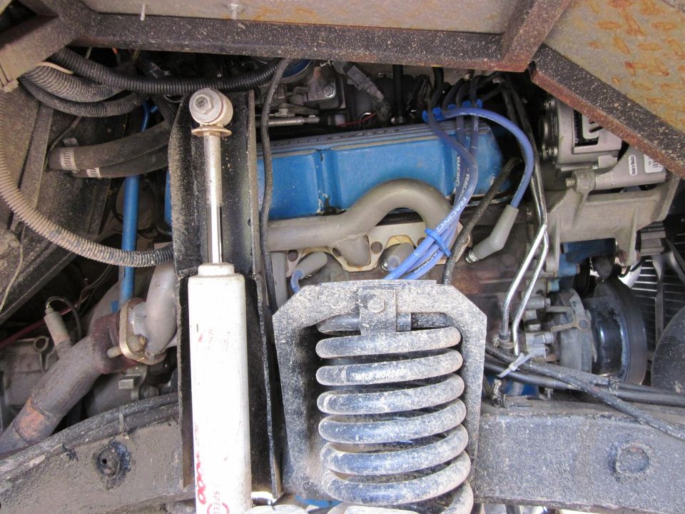 Engine bay with blue valve covers, shock absorber, and SuperMotors logo