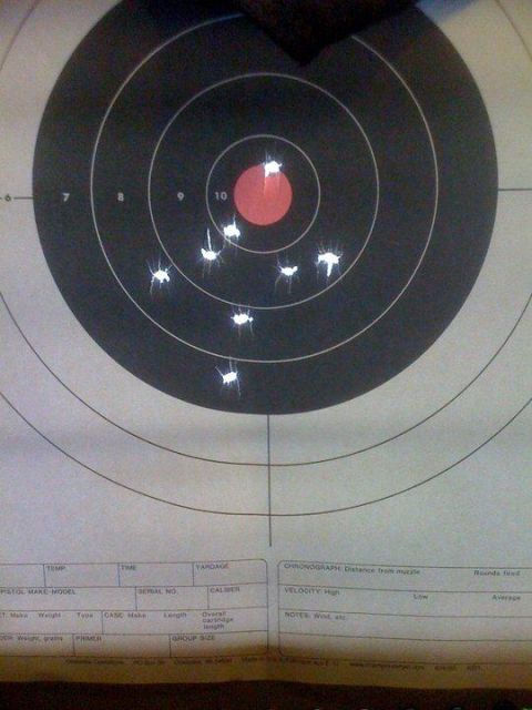 1991 Nissan Pathfinder - A target displays the results of a shooting session, with several bullet impacts visible.