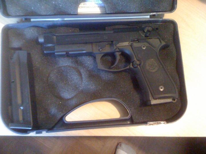 Pistol with magazine in a black case