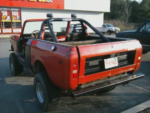 1978 International Scout II - Rear view of a red 1978 International Scout II with a roll cage and aftermarket bumper.