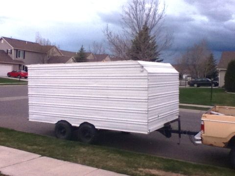 2006 Ford E350 - A white cargo trailer is parked on the side of the road in a residential area.