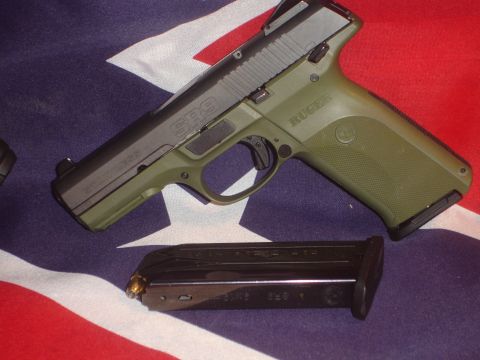 1989 Ford Bronco - Ruger SR9 pistol and its magazine are displayed on a flag. Text on the firearm is visible.