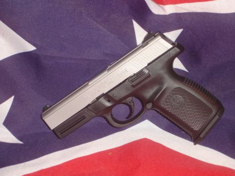 1989 Ford Bronco - A Smith & Wesson pistol is displayed on a flag, with text visible on the firearm.
