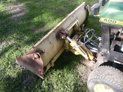 1966 Ford Bronco - Tractor with a snow plow attachment, showing the '400' model designation on the hood.