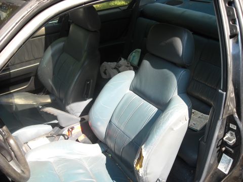 1979 Ford F-150 - Interior of a car showing damaged leather seats and the steering wheel.