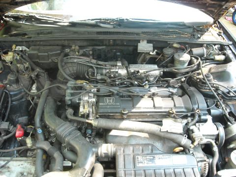 1979 Ford F-150 - The engine bay of a vehicle is shown, with the Honda motor prominently visible.