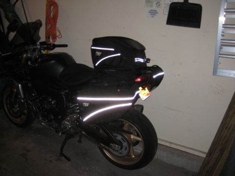 2008 Yamaha FZR1000 - Motorcycle equipped with reflective tape for increased visibility, parked in a garage.