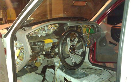 1992 Ford Ranger - The interior of a vehicle is shown with the dashboard removed and wiring exposed.