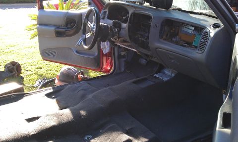 1992 Ford Ranger - The interior of a Ford Ranger is shown with the dashboard and carpet removed, indicating ongoing work.