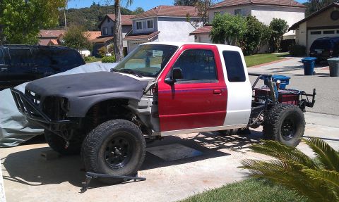 1992 Ford Ranger - This modified Ford Ranger displays a custom roll cage and off-road tires, indicating significant customization.