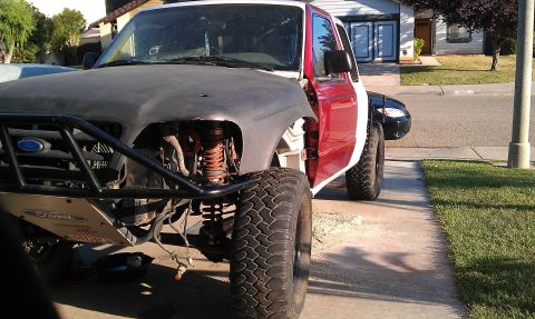 1992 Ford Ranger - This modified Ford Ranger is undergoing customization with large off-road tires and a custom front bumper.