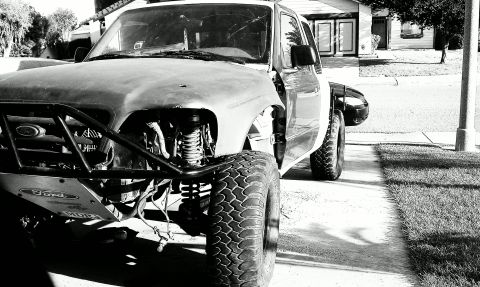 1992 Ford Ranger - This modified 1992 Ford Ranger features a custom front end and oversized tires, indicating off-road use.