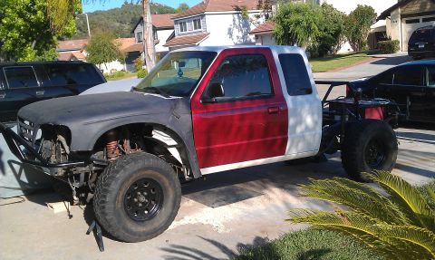 1992 Ford Ranger - This modified pickup truck appears to be a 1990s model, possibly a Ford Ranger, undergoing significant customization.
