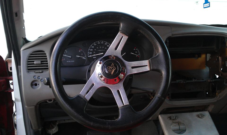 1992 Ford Ranger interior with aftermarket steering wheel and dashboard gauges visible