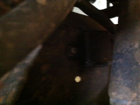 1990 Ford Bronco - A close-up view of the undercarriage of a vehicle, showing frame and suspension components.