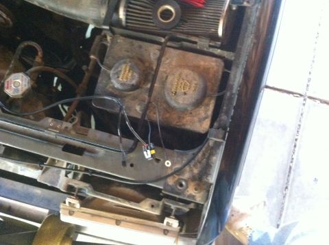 1990 Ford Bronco - Close-up view of engine bay components, including two reservoirs and electrical wiring.