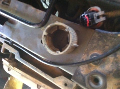 1990 Ford Bronco - A close-up view of a mechanical component within a vehicle, showing intricate details of its construction and surrounding parts.
